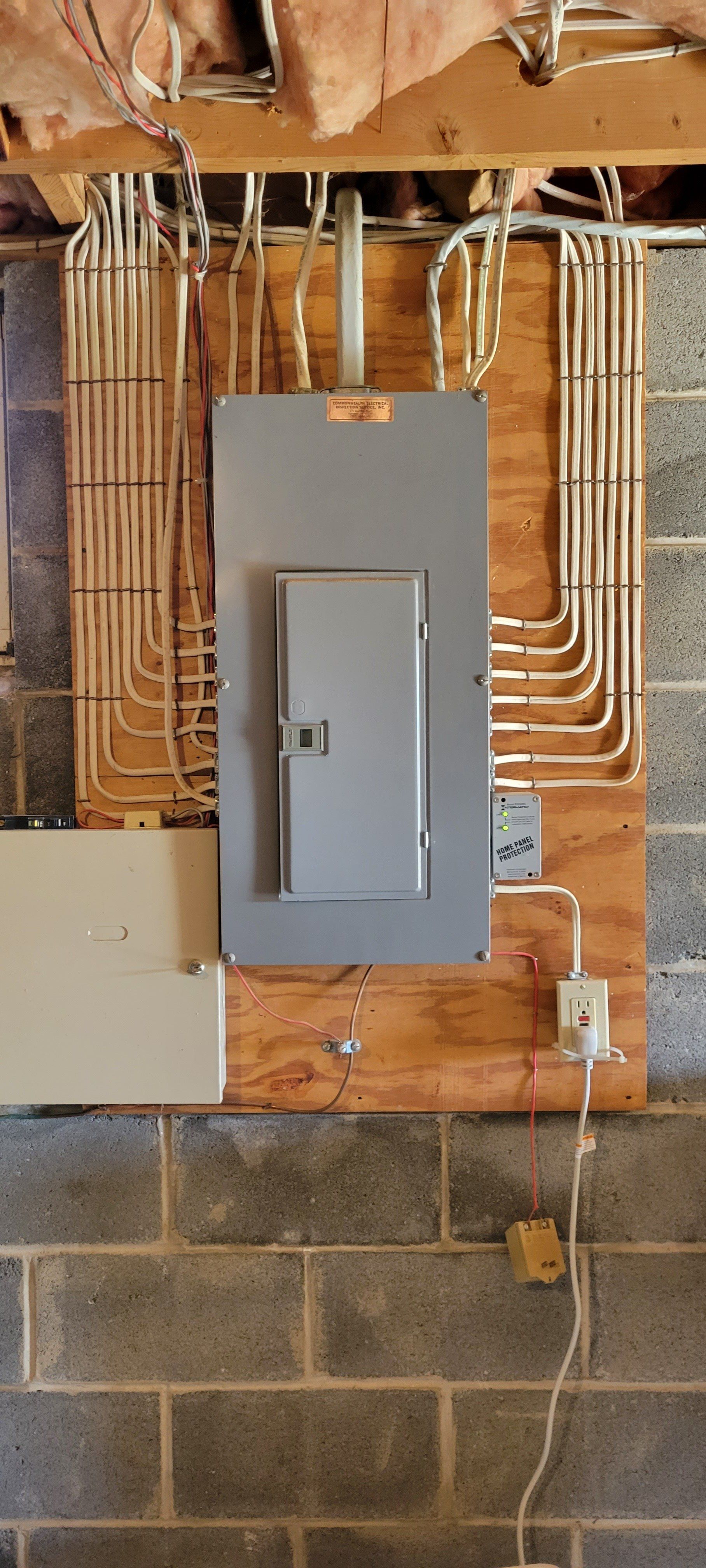 a electrical box is mounted on a brick wall in a basement .