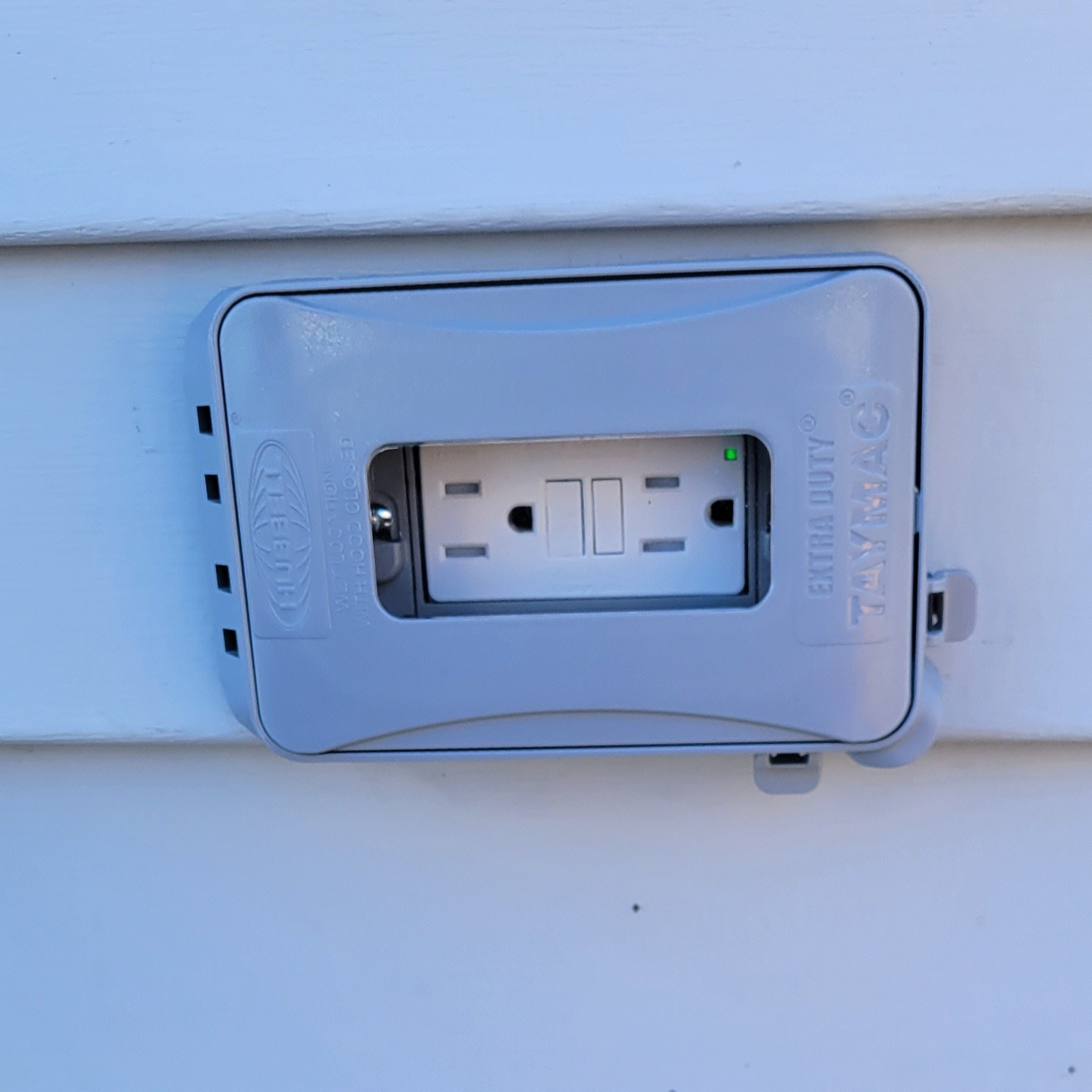 a close up of a electrical outlet on the side of a house .