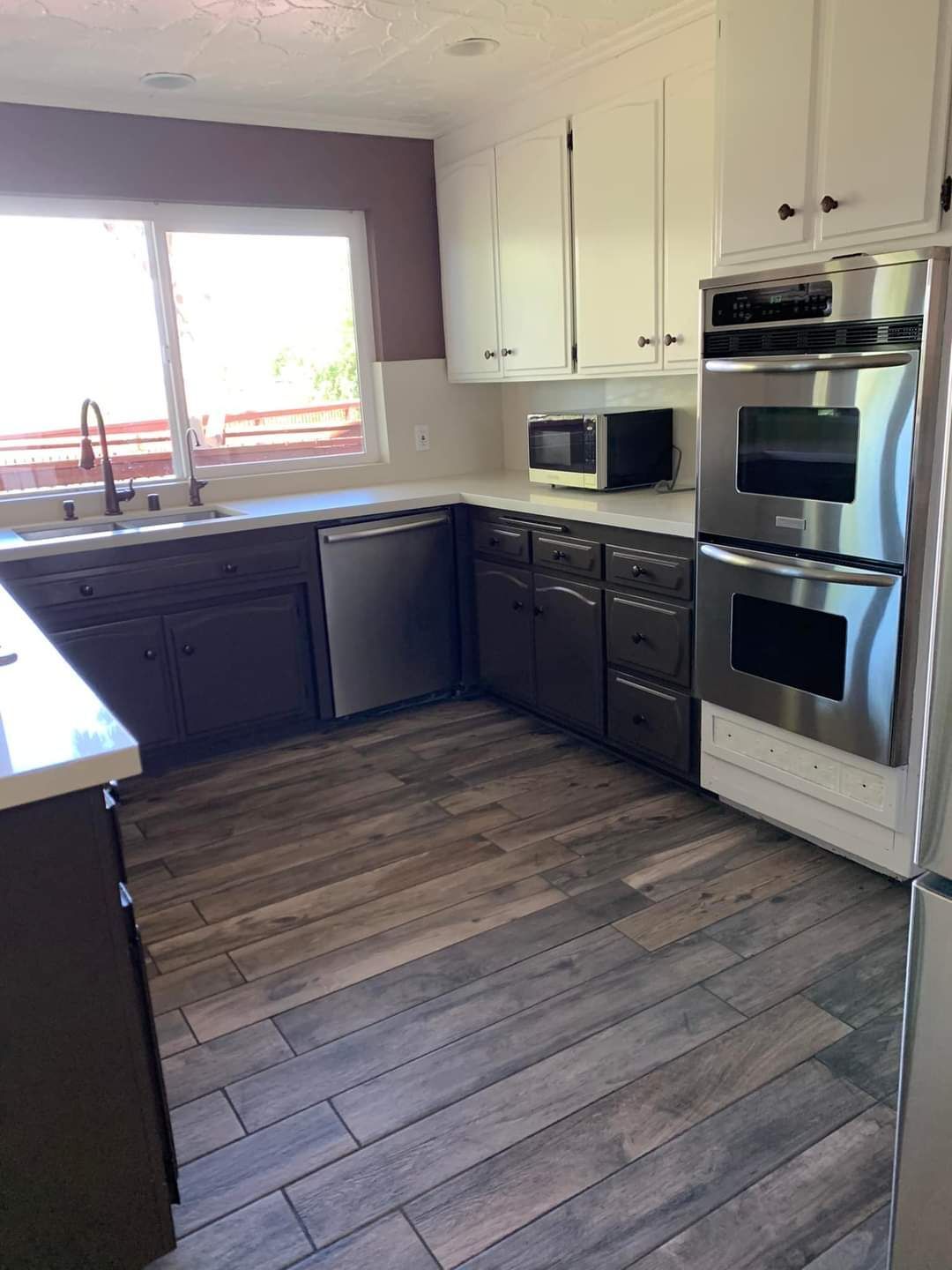 an image of a clean kitchen with the oven and sink