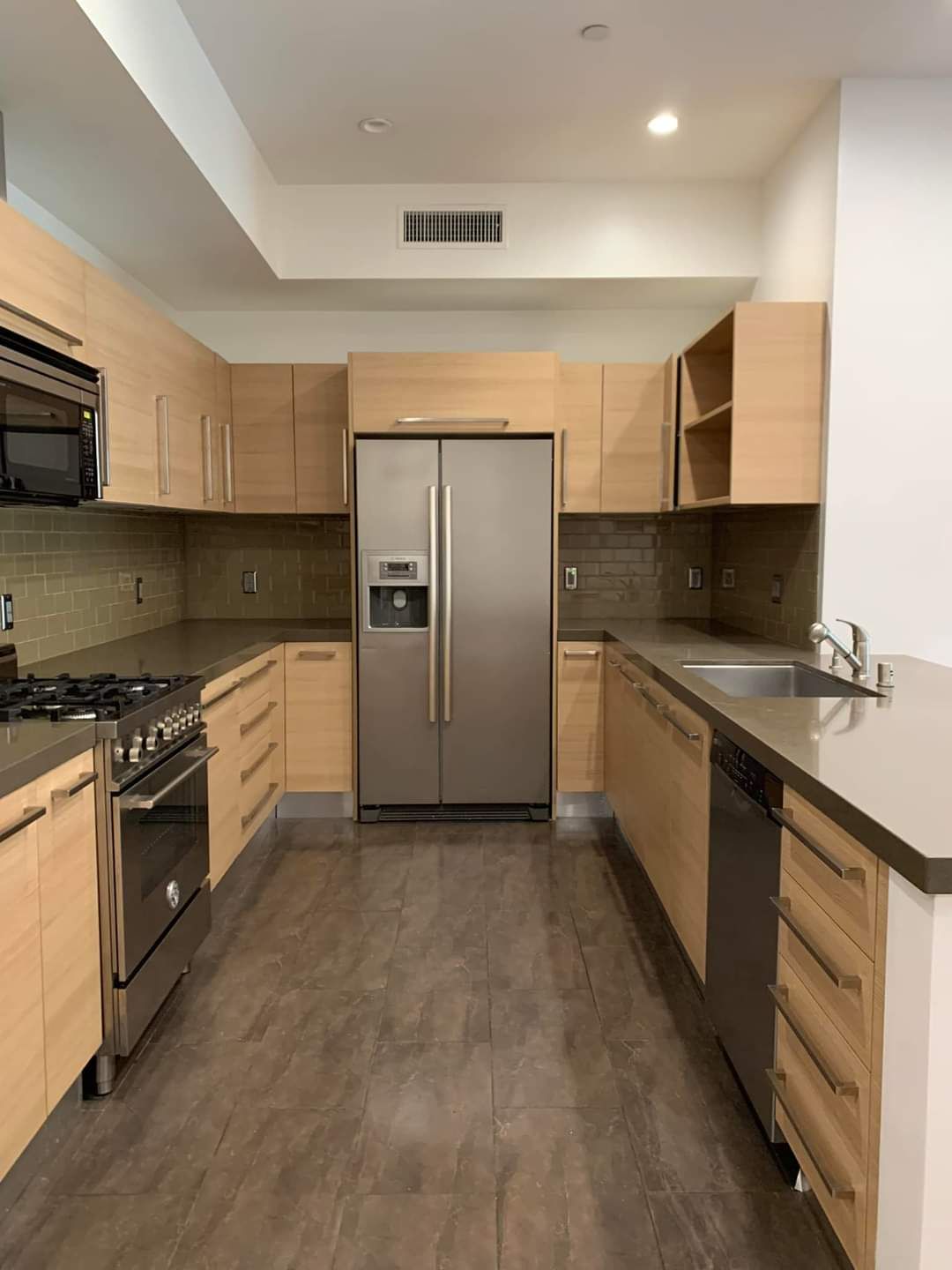 A cleaned kitchen with refrigerator