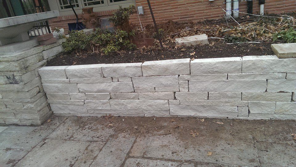 A brick wall with a planter in the middle of it.