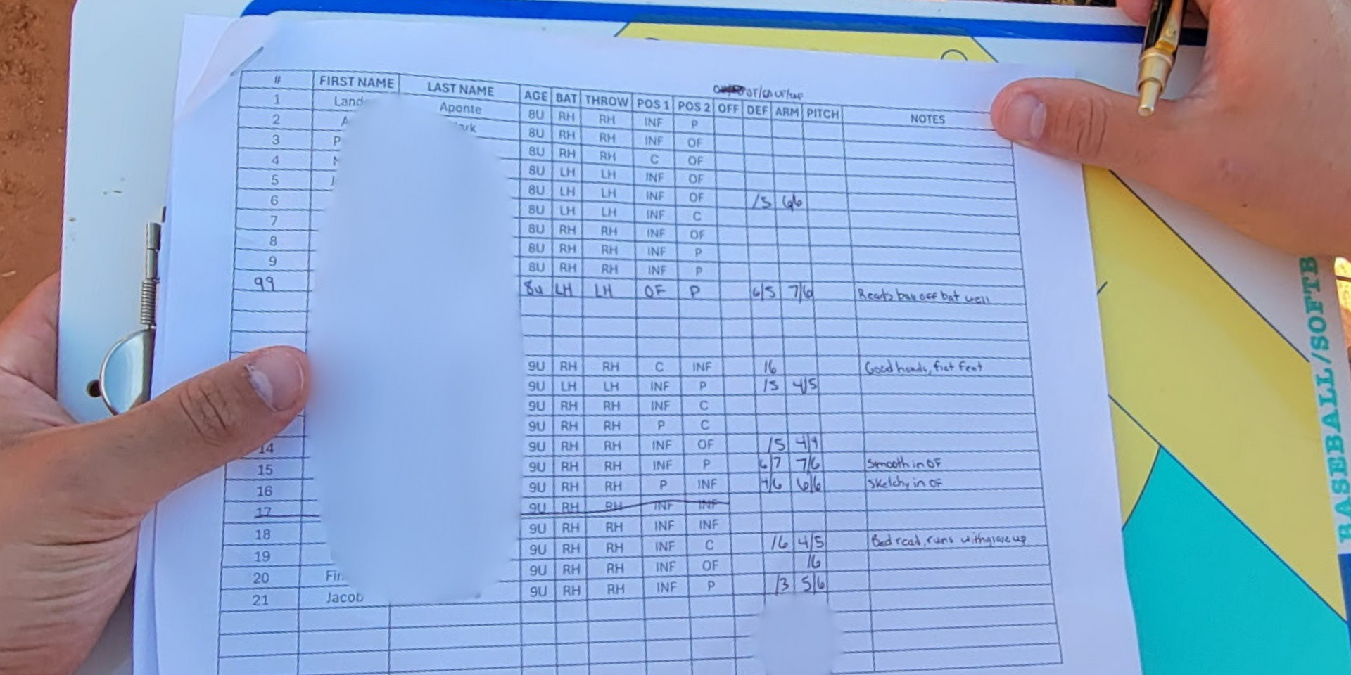 A person is holding a piece of paper with a grid on it.