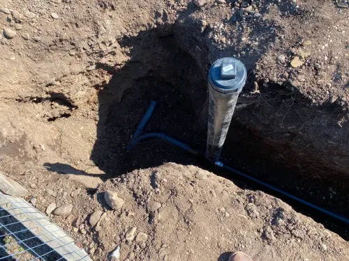 A hole in the ground with a pipe in it