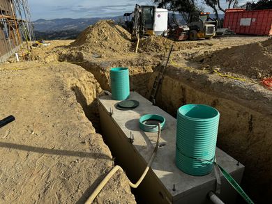 A construction site with a concrete block in the middle of the dirt.