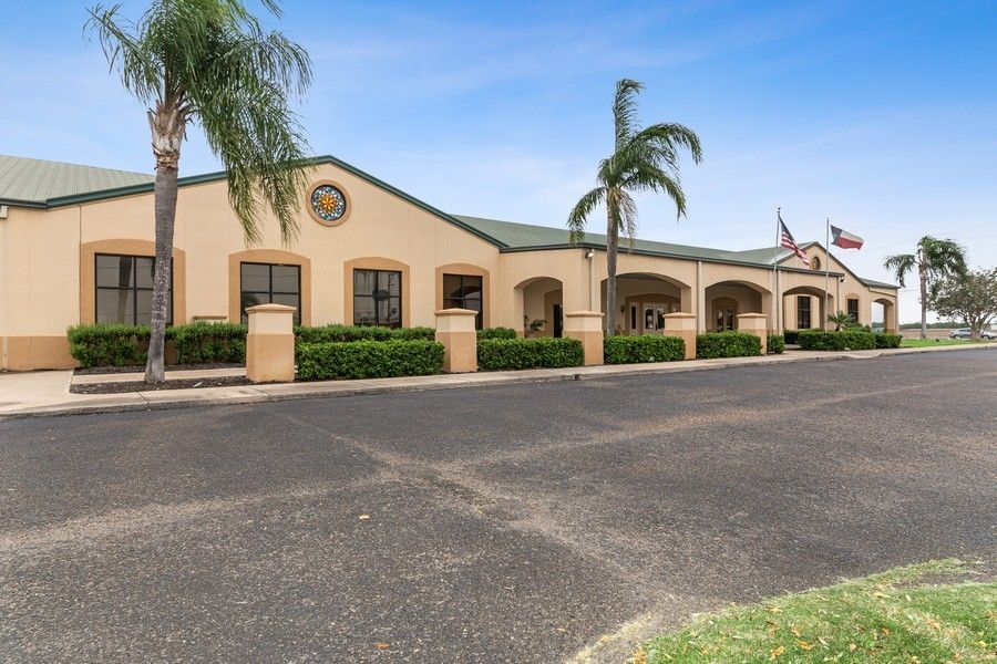 A large building with palm trees in front of it