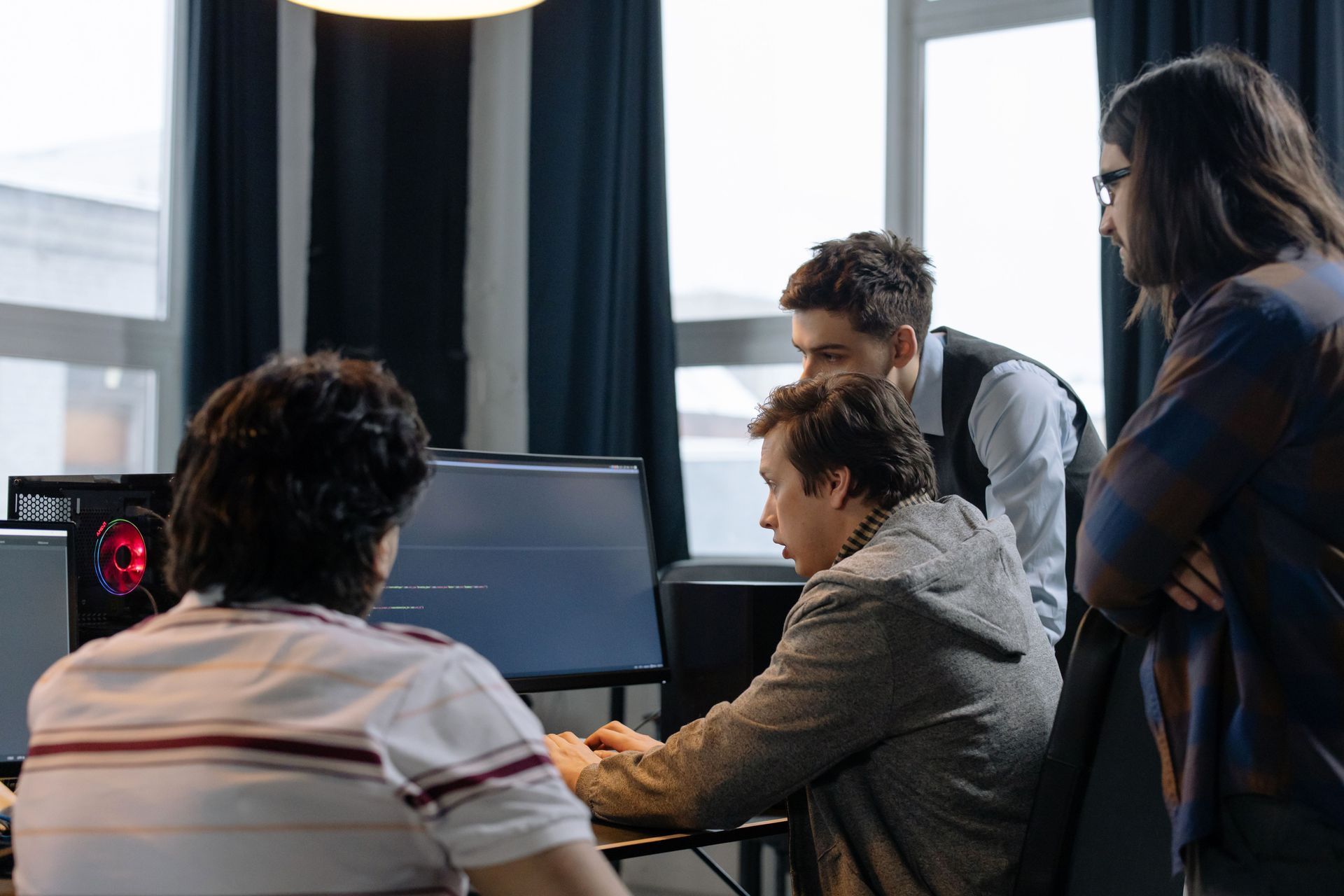 Engineering team reviewing an AI-generated incident report and anomaly detection dashboard on a large monitor during a standup meeting