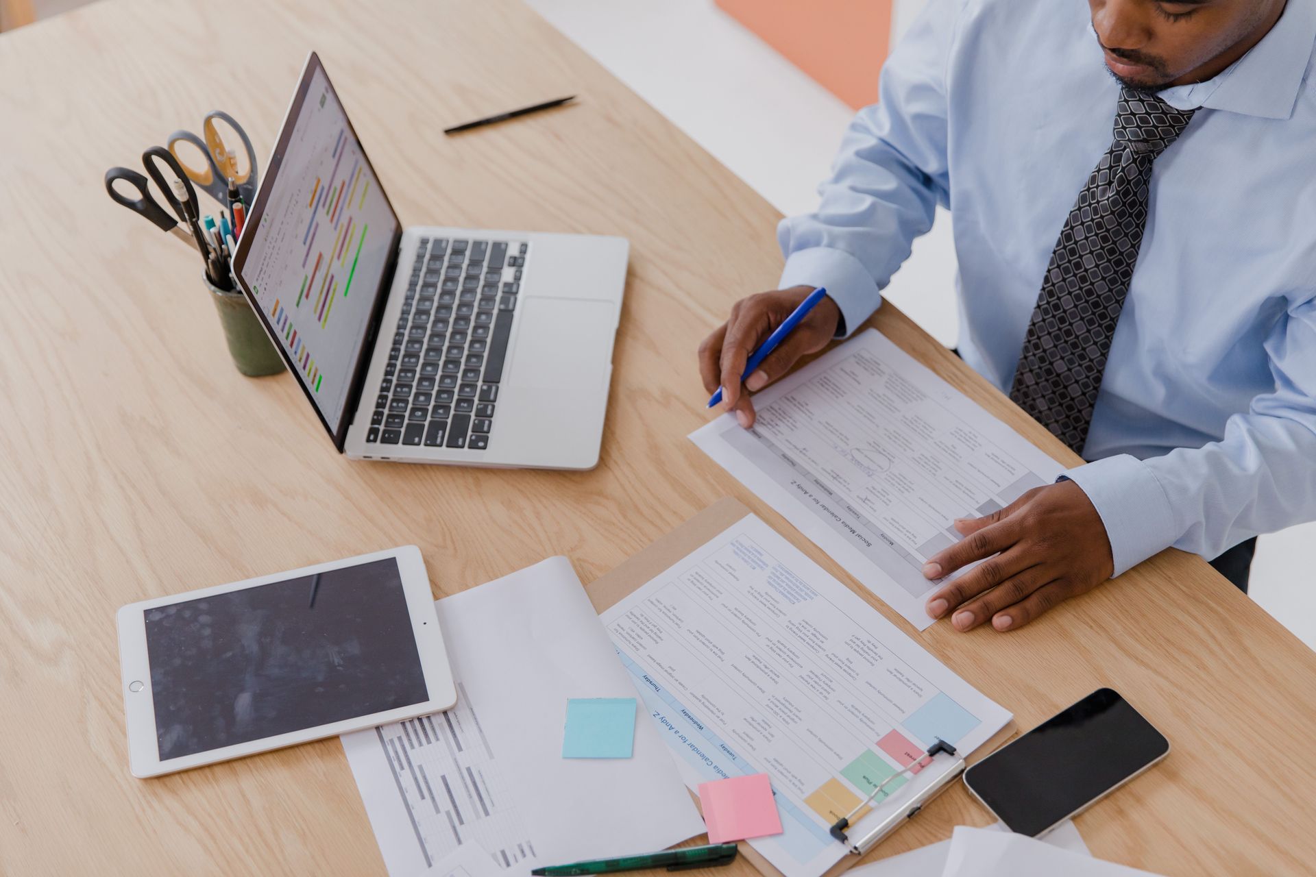 Entrepreneur thoughtfully reviewing a long-term business growth plan at a clean, organized desk