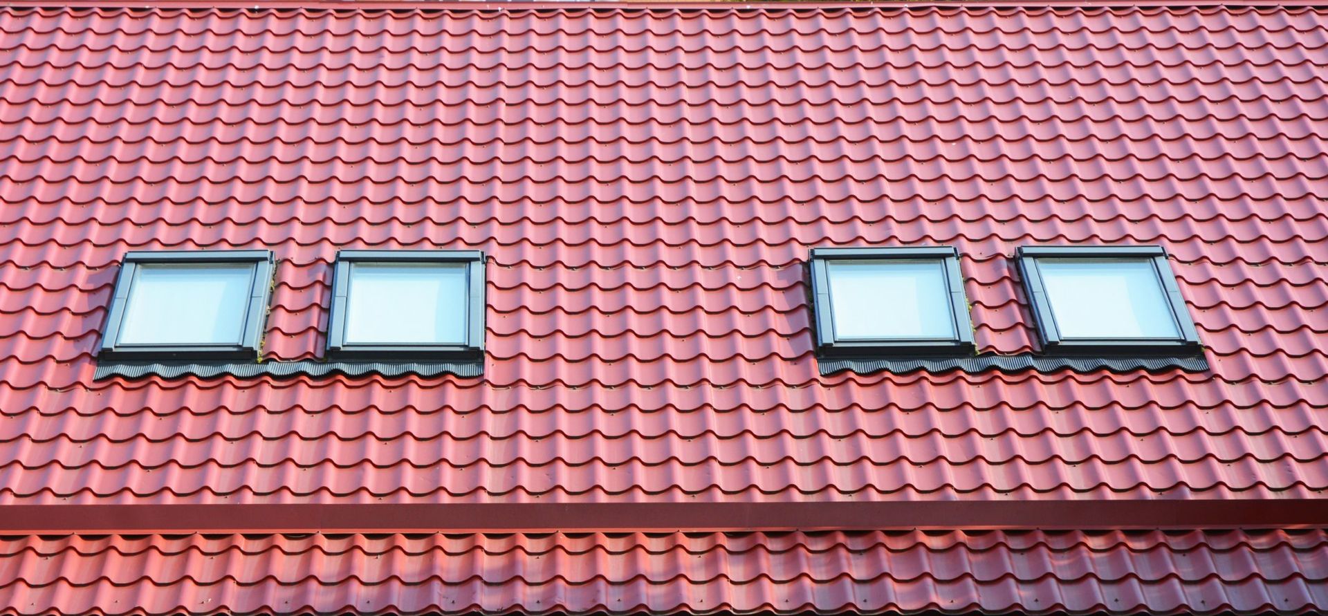 Red roof with four skylights.