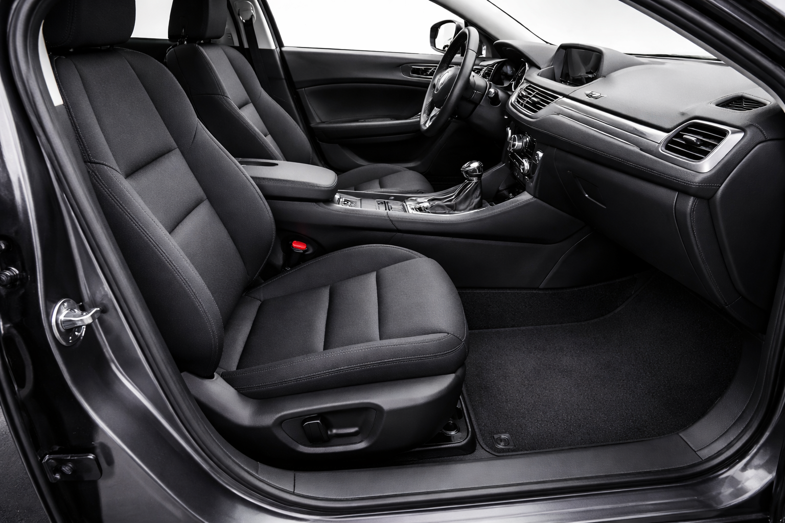 Black car interior with front seats, dashboard, and carpet.