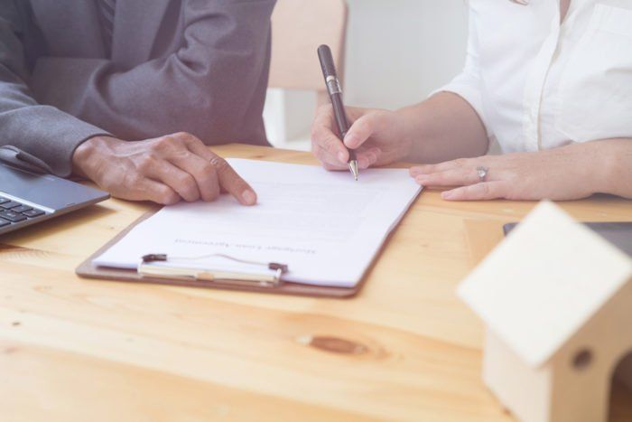 Person at desk writing on clipboard