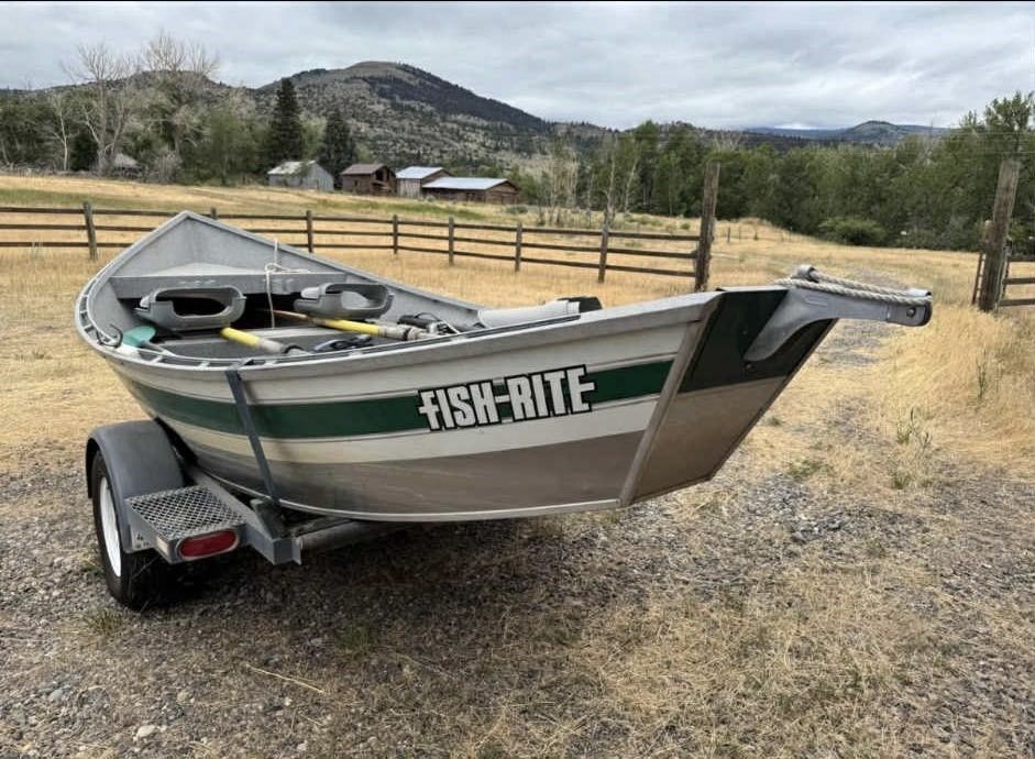 A wooden table topped with a variety of trays of food.