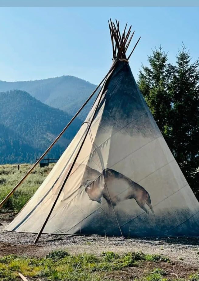 A teepee with a painting of a buffalo on it