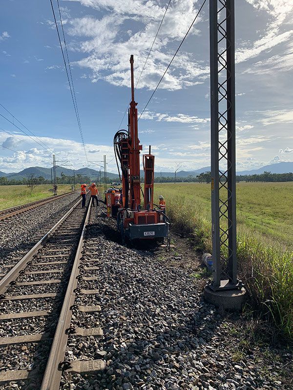 A Machine Is Parked on The Side of A Train Track — MK Drilling in Rosemount, QLD