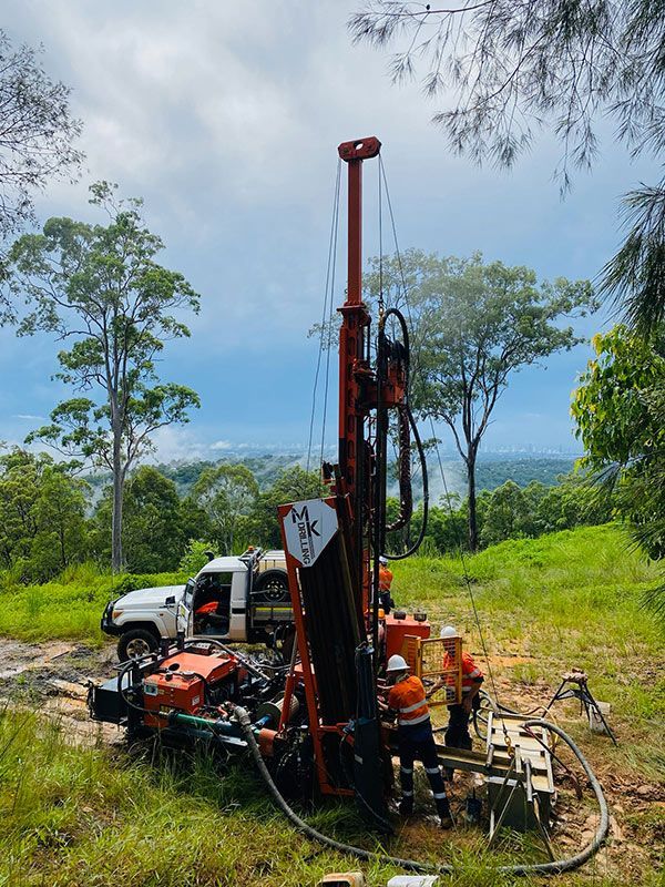 A Drilling Machine Is Parked in A Field For Drilling — MK Drilling in Rosemount, QLD