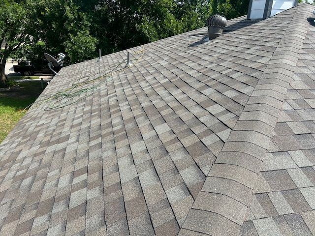 Close-up view of a brown asphalt shingle roof.