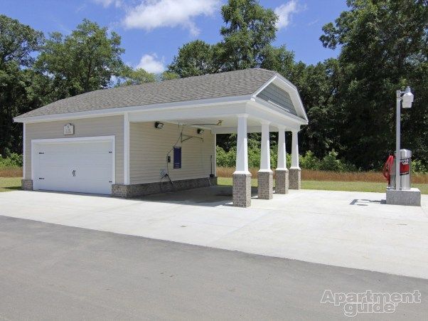 A garage with a roof that says apartment guide on it
