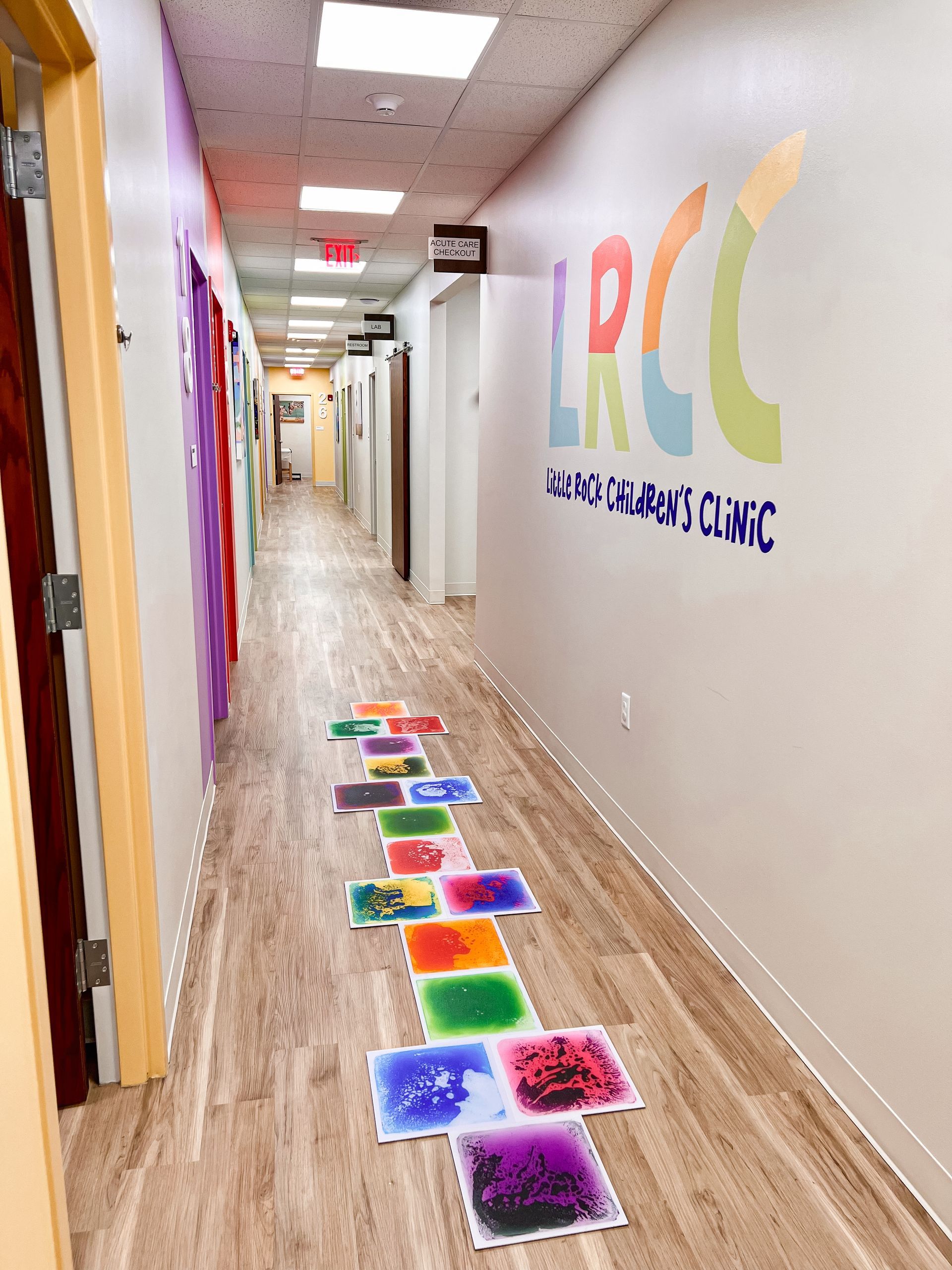 Hallway in a clinic with colorful liquid floor tiles; LRCC clinic sign on the wall.