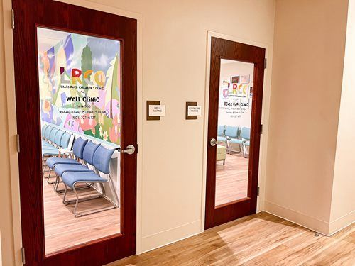 Two doors with glass panels; waiting rooms. Blue chairs visible. Signage: LRCC, NYS OMH Clinic.