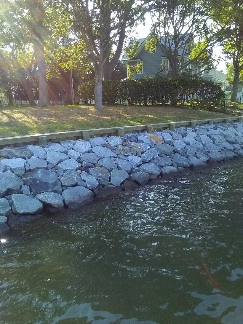 A Large Body of Water Is Surrounded by Rocks on A Sunny Day.