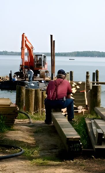 A Black and White Photo of Men Working on A Dock