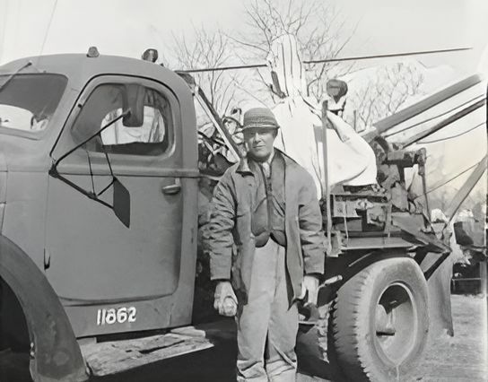 A Black and White Photo of A Man Standing Next to A Truck with The Number 111862 on The Side A Black and White Photo of A Man Standing Next to A Truck with The Number 111862 on The Side