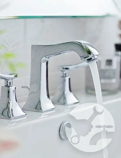 Chrome bathroom faucet with water running; a close-up of the faucet's hardware is featured.