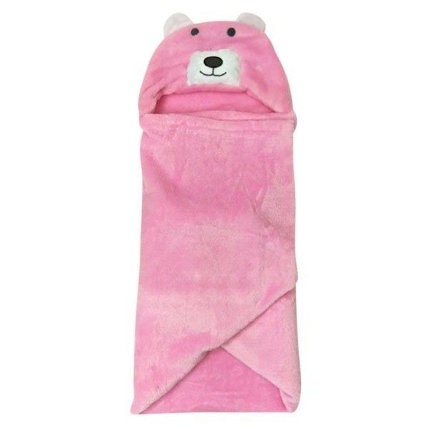 Een roze teddybeerdeken ligt op een houten tafel.