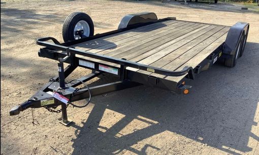 A trailer is sitting on the ground in a parking lot.