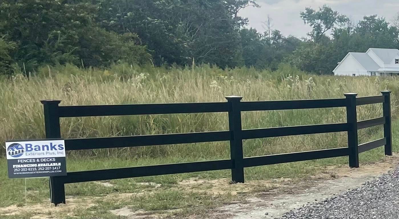 Brown wooden fence in a yard next to a building on a sunny day. Brown wooden fence in a yard next to a building on a sunny day.
