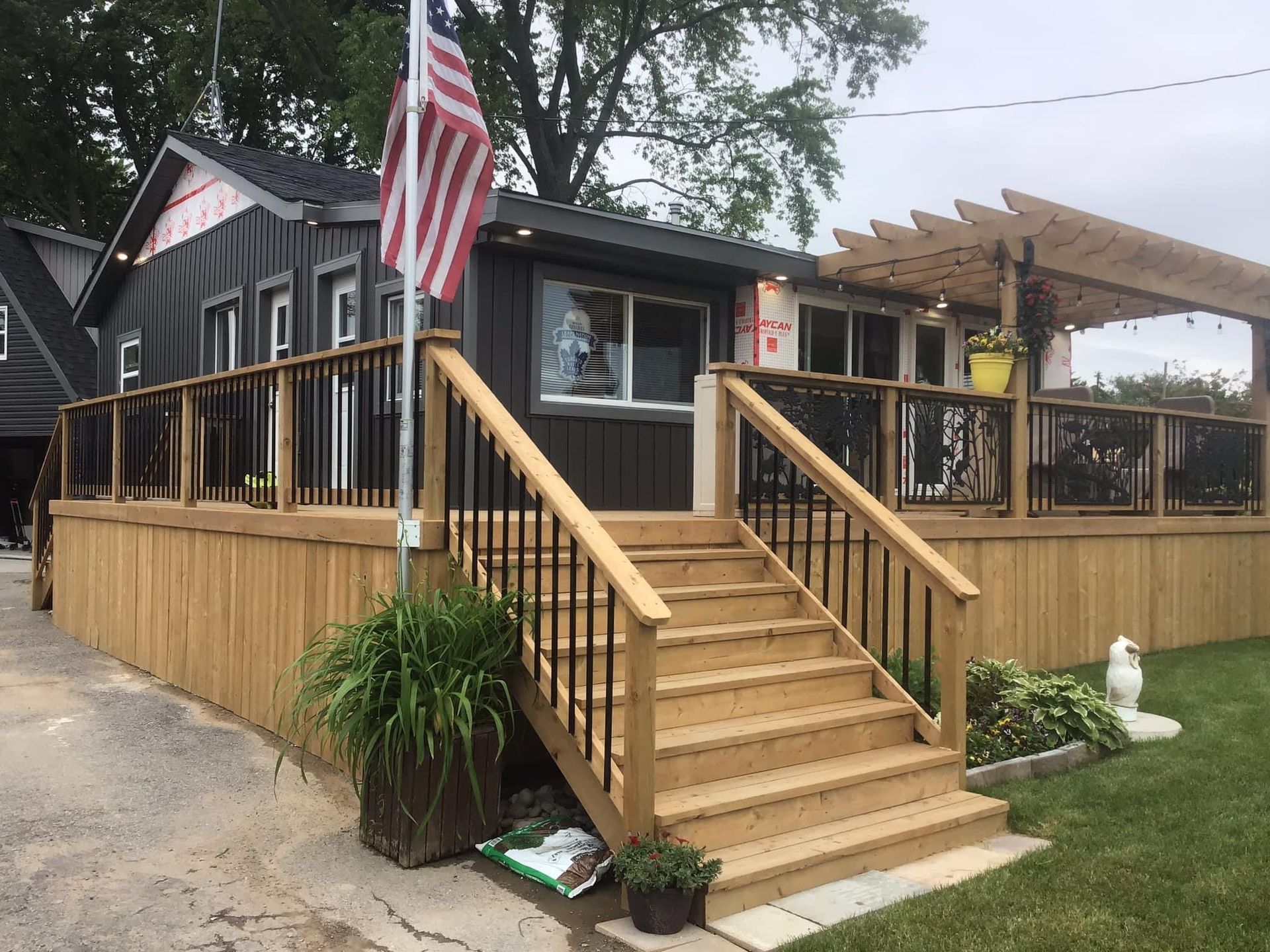 A house with a wooden deck and stairs in front of it built by Ironside Construction