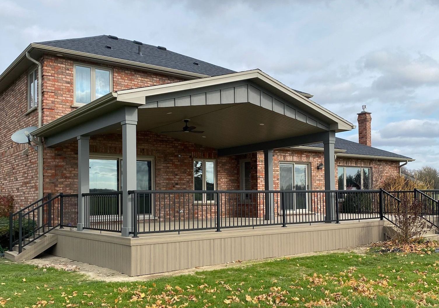 A large brick house with a large covered porch built by Ironside Construction