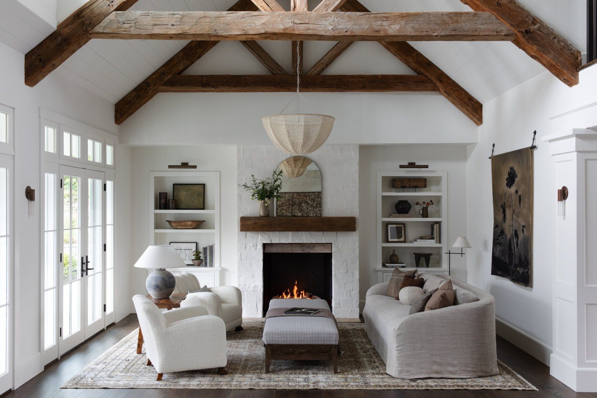 Inviting Los Angeles real estate property of LKP Group living space with a cozy fireplace and elegant white furniture