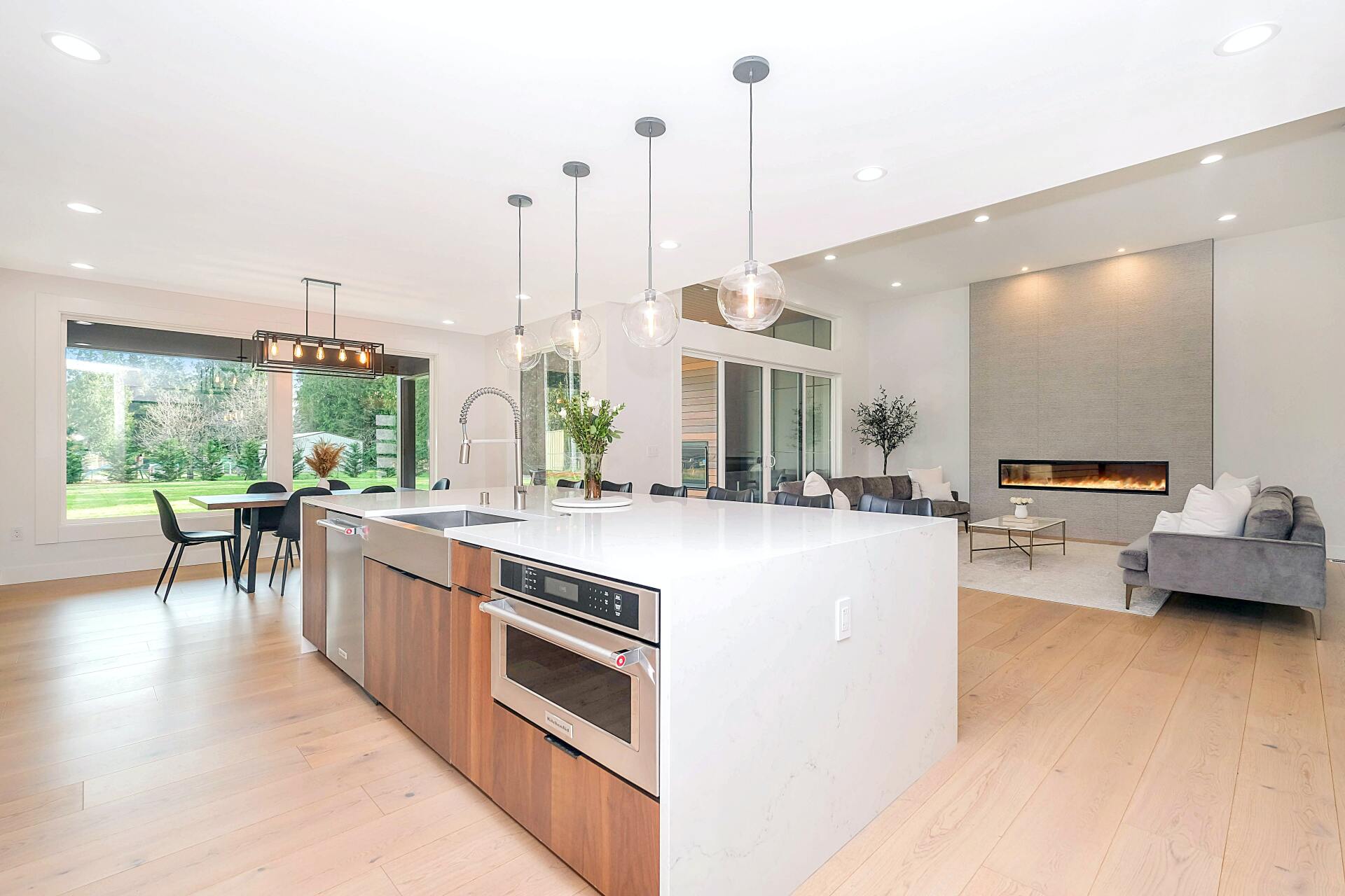 Contemporary kitchen with stainless and wooden accents, with a living room featuring a fireplace Los Angeles homes for sale by Lisa Kirshner Properties