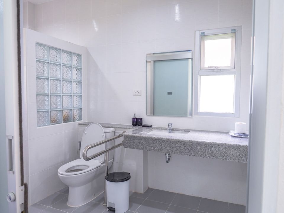 A Bathroom With a Toilet, Sink and Mirror — Dawsons Cleaning Specialist In Mount Louisa, QLD