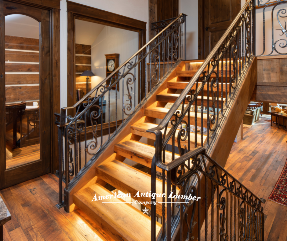 Wooden stair case with decorative wrought iron banister and stair riser lights.