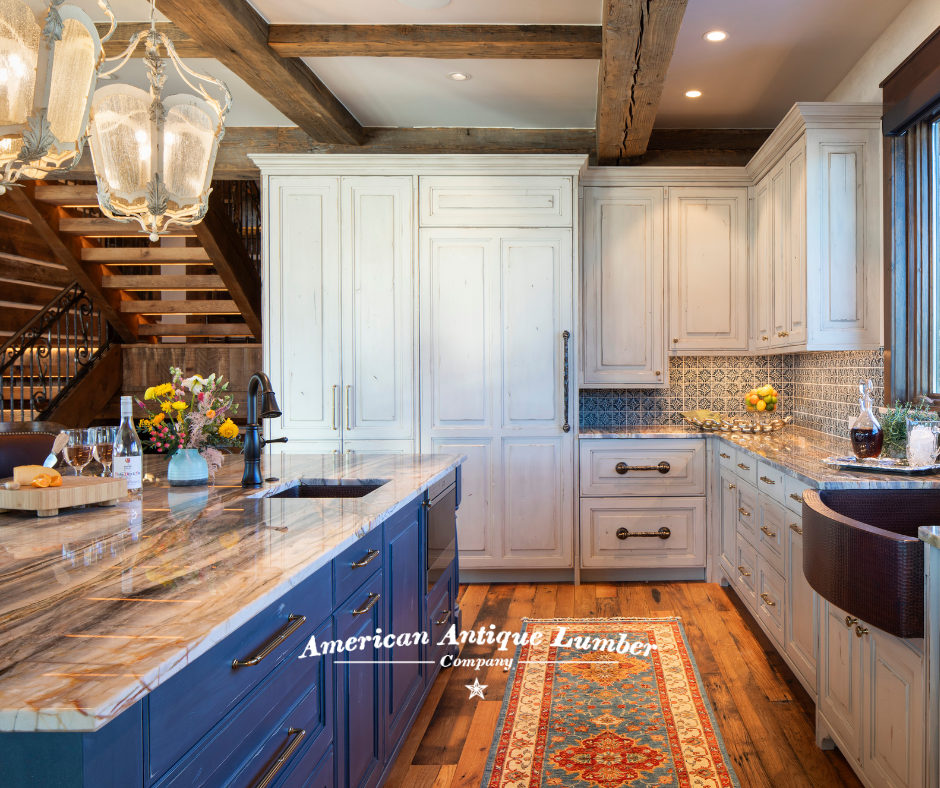 White kitchen cabinets with wood floors and blue center island.