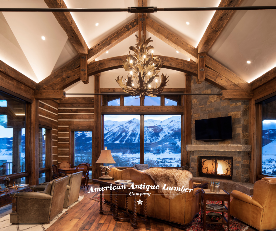 Reclaimed decorative wood trusses, moose antler chandelier, with Colorado mountains seen through the windows and dusk.