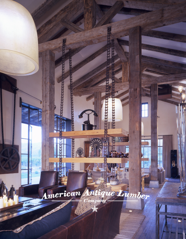 Industrial style dining room has shelves hung with metal chains flanked by reclaimed hand hewn timbers. 