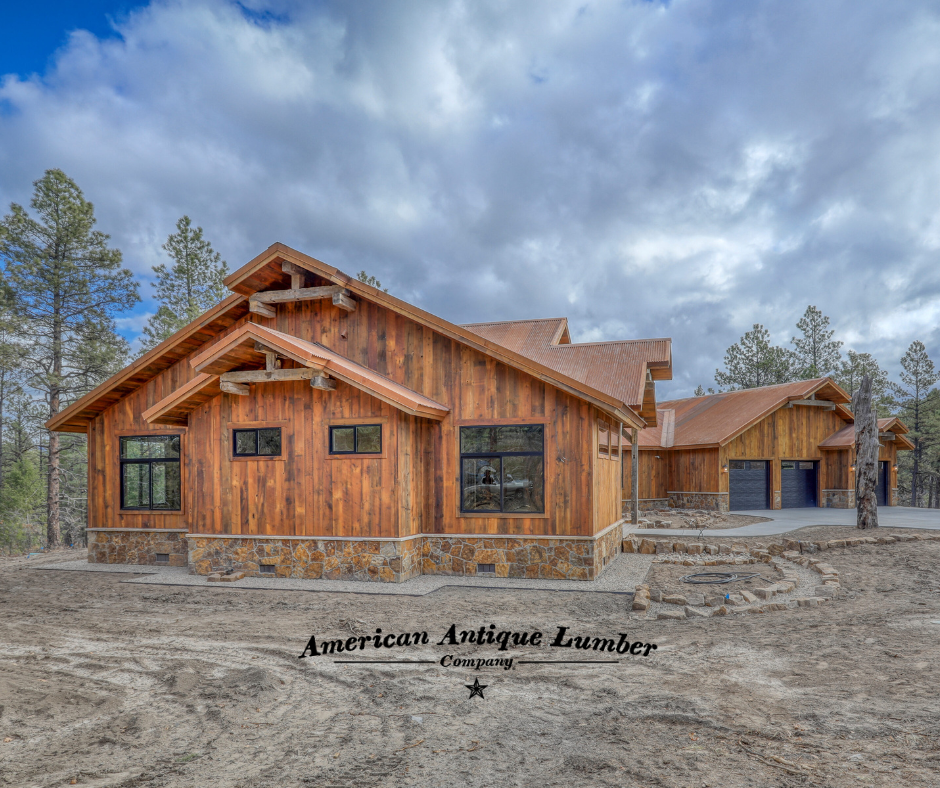 Home with reclaimed wood and stone surrounded by pine trees and dark clouds in Pagosa Springs, Colorado. 