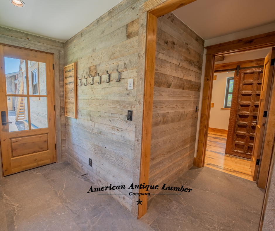 Wood clad mudroom area with hooks for coats. 