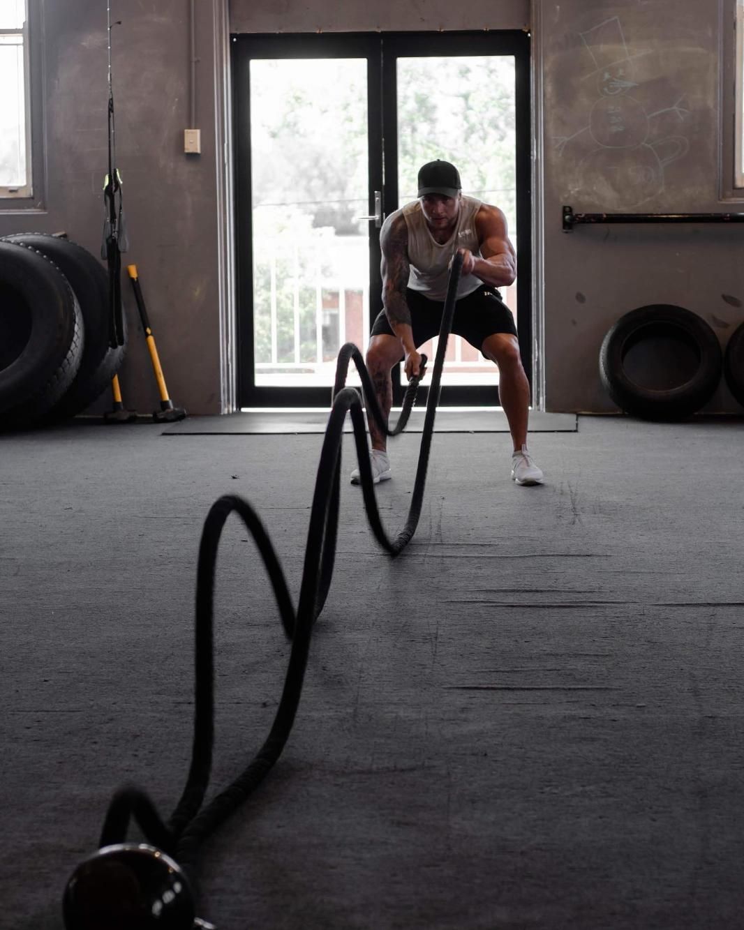 A Man is Working Out With a Rope in a Gym — The Factory Gym in Taree, NSW