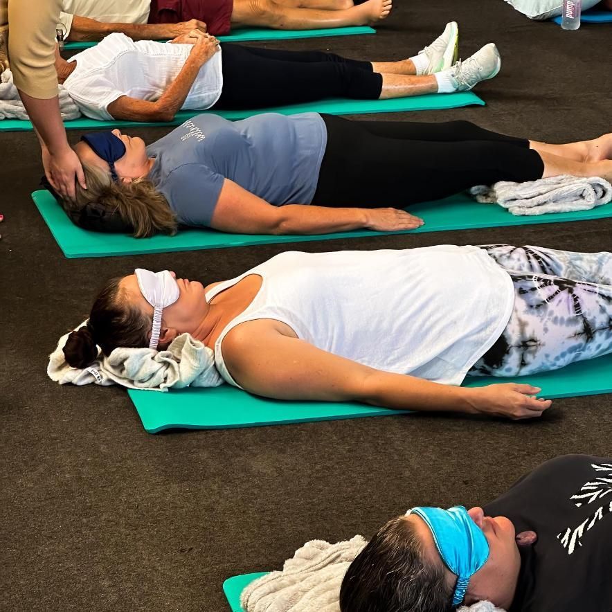 A Group of People Are Laying on Yoga Mats With Their Eyes Closed — The Factory Gym in Taree, NSW