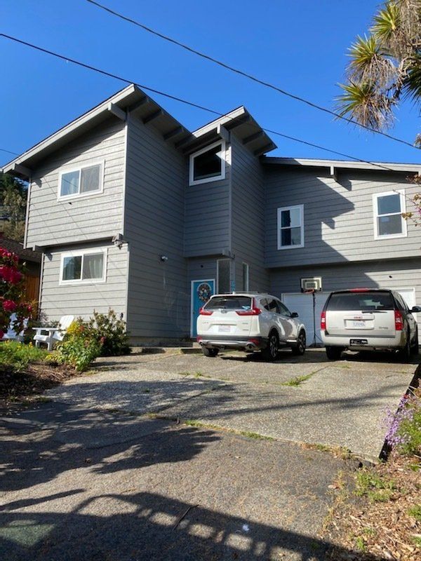 House Exterior With Two Vans — Santa Cruz, CA — Better Roofing With Travis