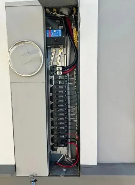 A electrical box with a lot of wires coming out of it.