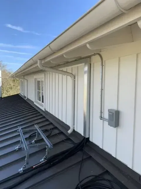 There is a ladder on the roof of a building.
