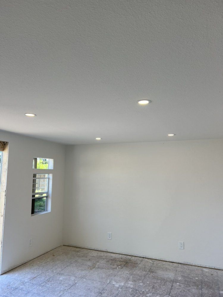 An empty room with white walls and a window.