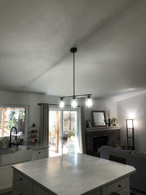 A kitchen with a large island and a fireplace