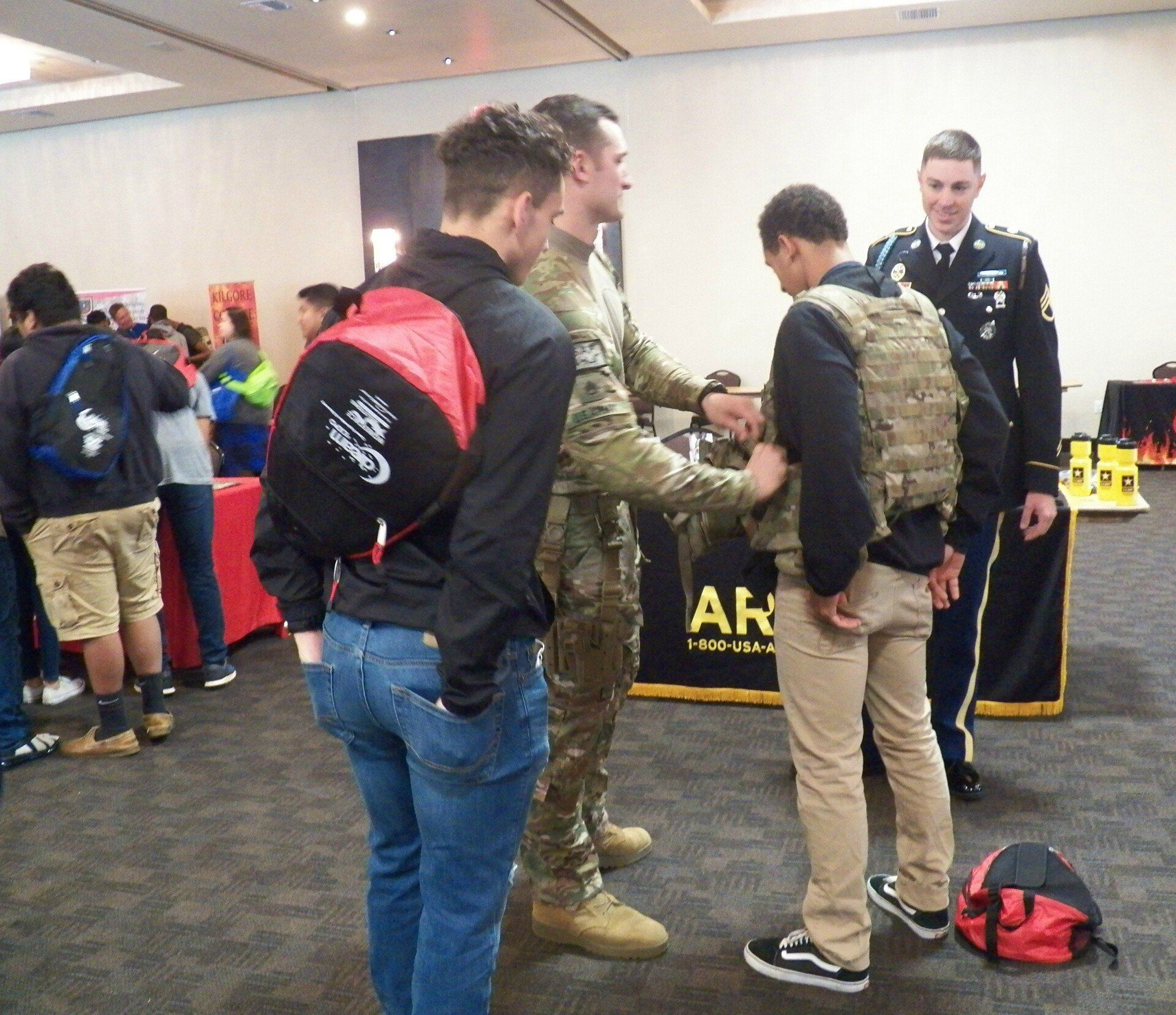 A group of men are standing in front of a sign that says ar