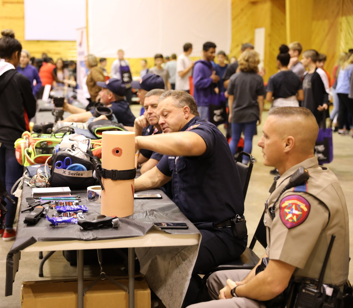 A group of police officers are sitting around a table