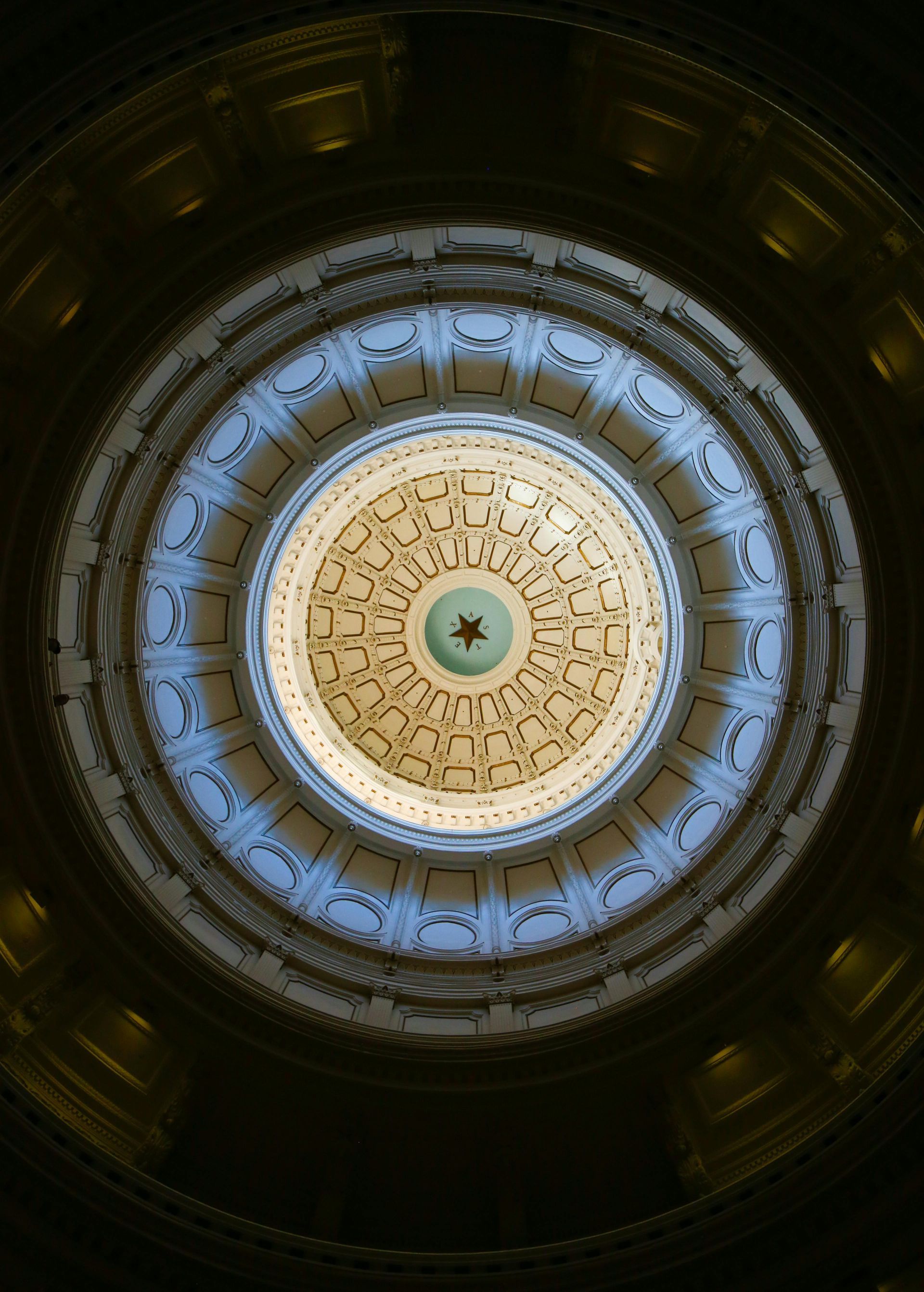 Looking up at a dome with a star in the center